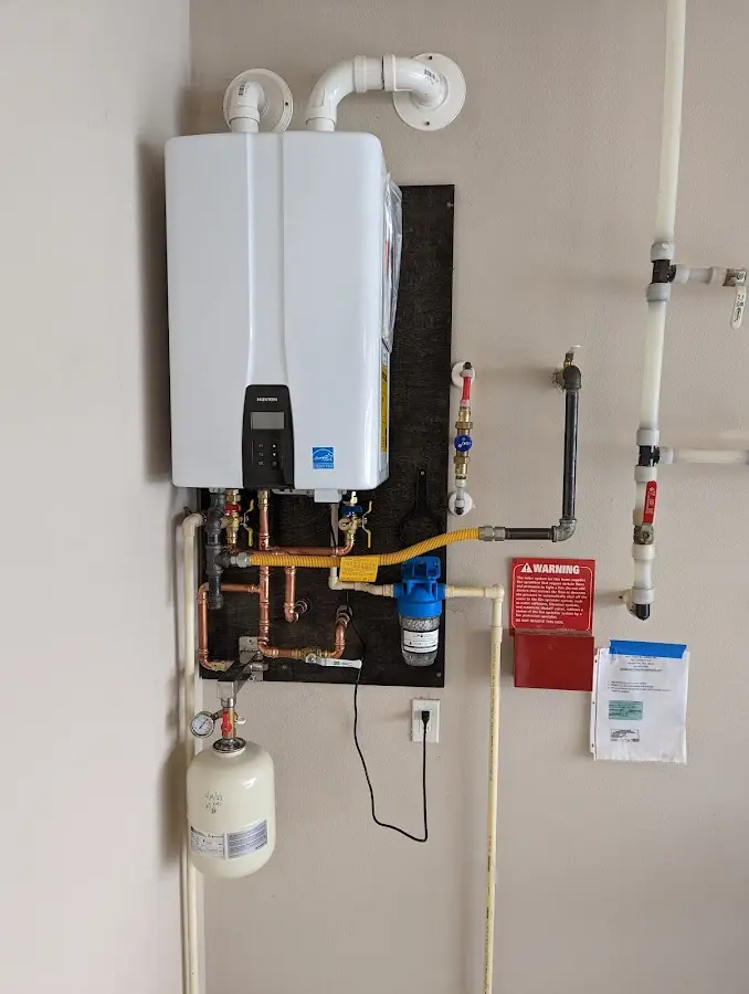 Professional plumber installing copper piping in a Barnesville home